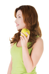 Woman holding an apple and looking somewhere