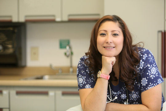 Young Female Nurse Engaged In Conversation