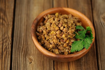 Cooked lentils in wooden bowl