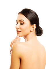 Fototapeta premium Back view of naked woman touching her chin