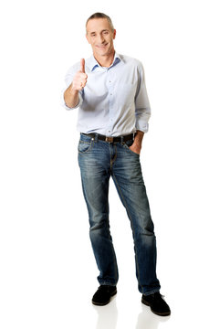 Full length mature man gesturing ok sign