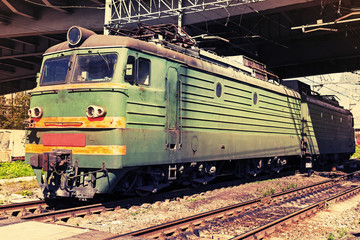 Obraz premium Green modern Russian locomotive with red stripes on cabin