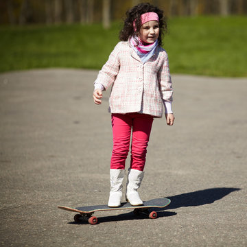 little girl skating on the street