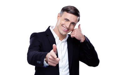 Businessman shows 'phone me' gesture and point towards camera