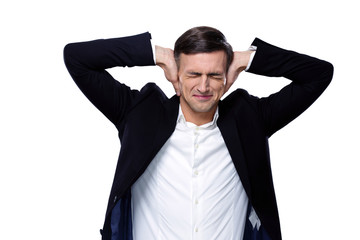 Businessman holding hands on the ears over white background