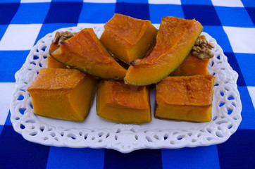 Juicy squash cut into pieces on a white tray