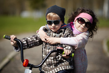 Fototapeta na wymiar girl and boy riding on bicycle
