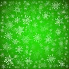 Green Christmas background with different snowflakes