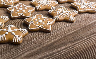 Gingerbread stars with spices on wooden background