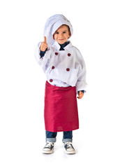 child dressed as a chef with thumb up