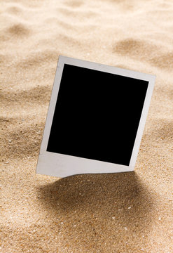 Old style empty photo cards on a sea sand