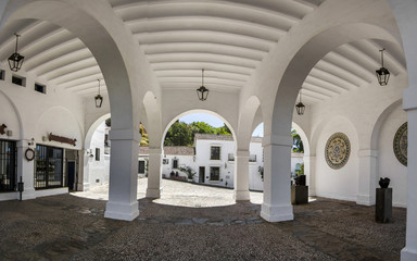View of beautiful arcs of a building located in Aracena, Spain.