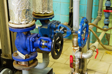 Pipes and faucet valves of heating system in a boiler room