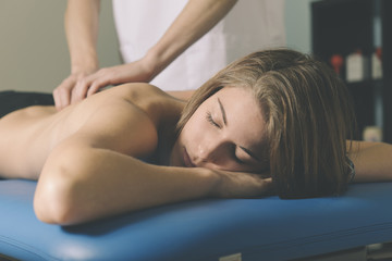 Obraz premium Beautiful young woman relaxing with hand massage at beauty spa