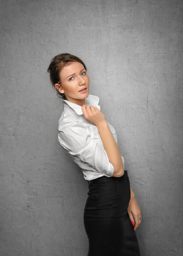 Pretty smiling young woman in office clothes