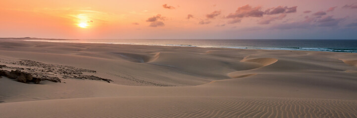 Fototapeta na wymiar Sunset on sand dunes in Chaves beach Praia de Chaves in Boavist