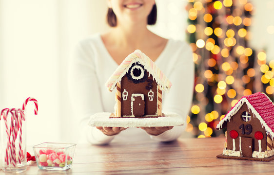 close up of woman showing gingerbread house