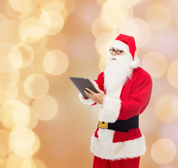 man in costume of santa claus with tablet pc