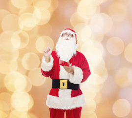 man in costume of santa claus with notepad