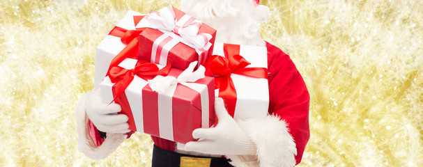 close up of santa claus with gift box