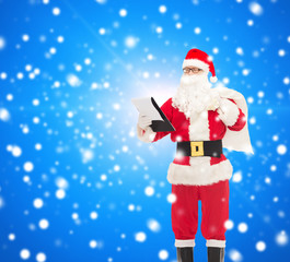 man in costume of santa claus with notepad and bag