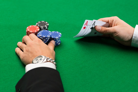 poker player with cards and chips at casino