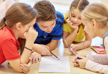 group of students talking and writing at school