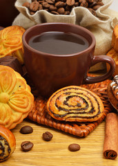 Fototapeta na wymiar Cup of coffee with biscuits, coffee beans in bags and cinnamon s