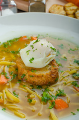 Beef broth with toast and egg benedict