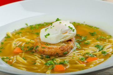 Beef broth with toast and egg benedict