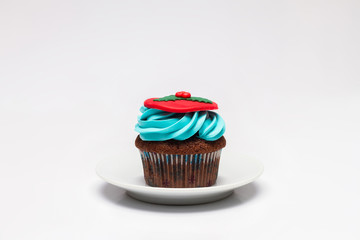 Cupcake with butter cream icing on the saucer. Christmas