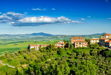 Fototapeta premium Wonderful Tuscan countryside in spring. Small town on a beautifu