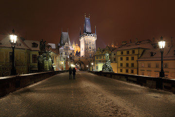 Naklejka na ściany i meble Night colorful snowy Prague gothic Castle from Charles Bridge