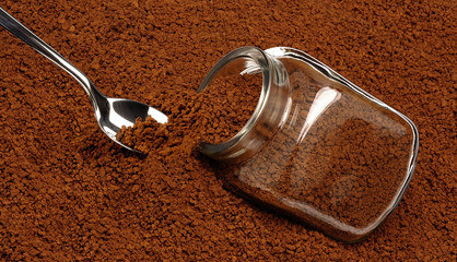Coffee spoon inserted into granular instant coffee.