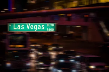 Fototapeten Las Vegas Boulevard street sign at night with motion traffic. © nuinthesky