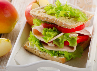 Sandwich with  apple on  wooden table