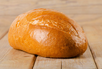 Fototapeta premium Fresh white bread on wooden background