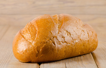 Fresh white bread on a wooden background