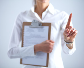 Woman touching an imaginary screen with her finger , holding a