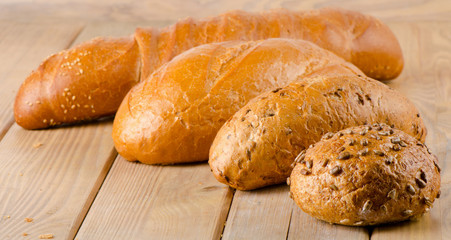Fresh baked  white bread on   wooden table.