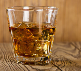 Glass of whiskey on  wooden table