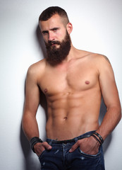 Fototapeta premium Portrait of handsome bearded man standing, isolated on grey