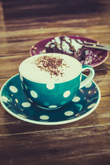 Hot Cappuccino coffee and brownie cake with vintage filter