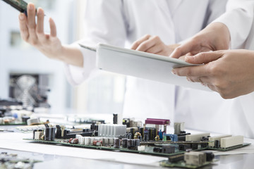 Engineers are working with an electronic tablet