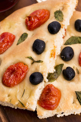 Focaccia with black olives, tomatoes and basil