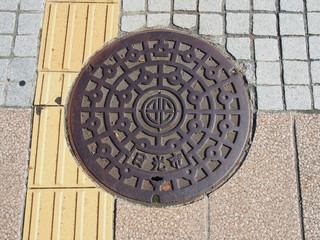 Manhole drain cover on the street at Nikko, Japan