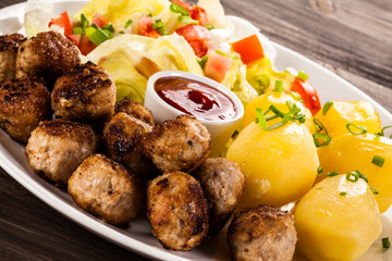 Roast meatballs, French fries and vegetable salad
