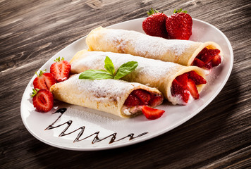 Pancakes with cream and strawberries
