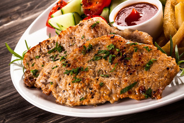 Pork chops, French fries and vegetables