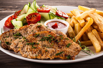 Pork chops, French fries and vegetables